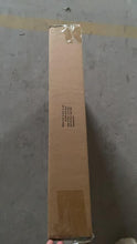 Cardboard box sealed with tape, showing shipping details, resting on a flat surface.
