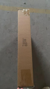 Cardboard box sealed with tape, showing shipping details, resting on a flat surface.